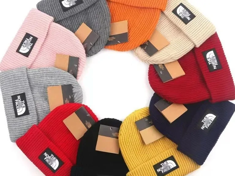 Knit beanies in about fifteen colours arranged in a ring with logo patches facing out
